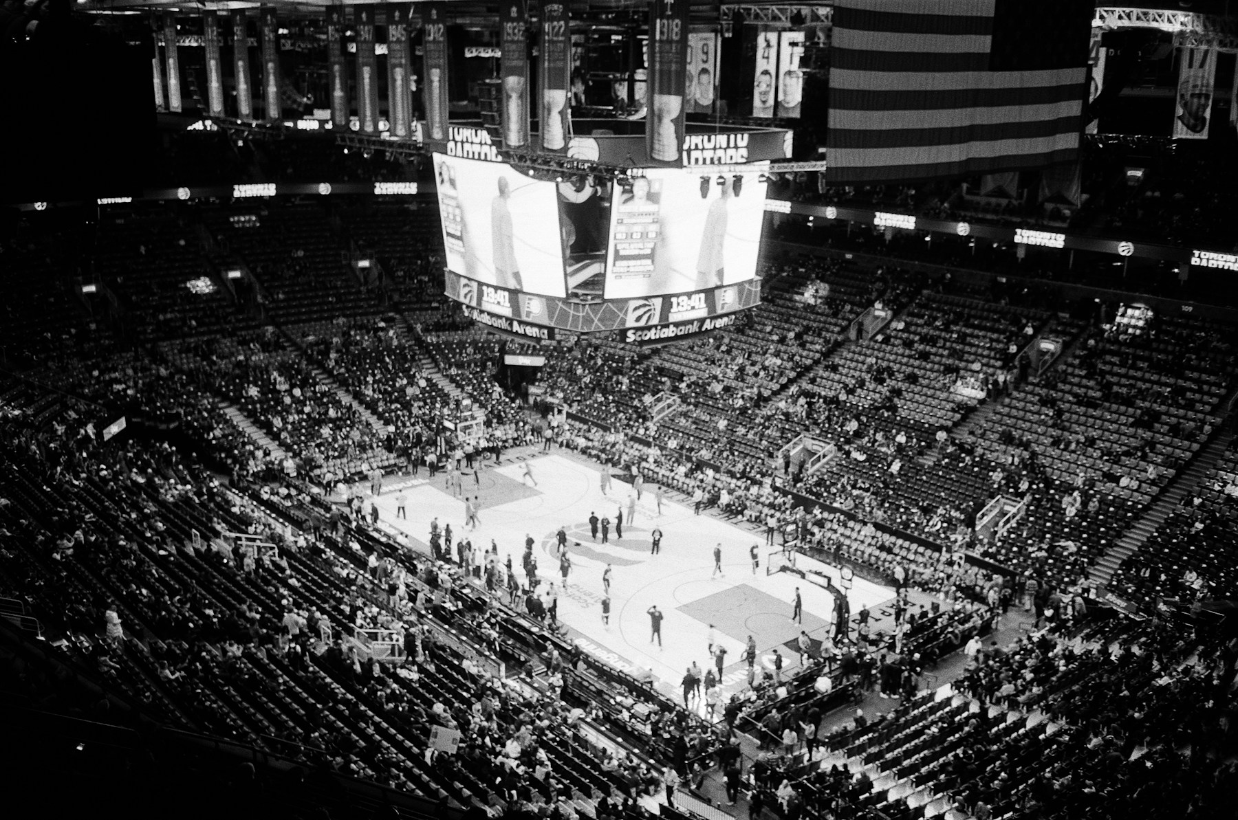 Packed basketball game in a bright arena with crowd energy